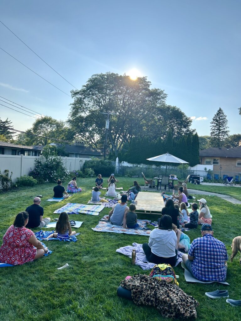 The Wellness Warriors in the grass ready to receive a sound bath.